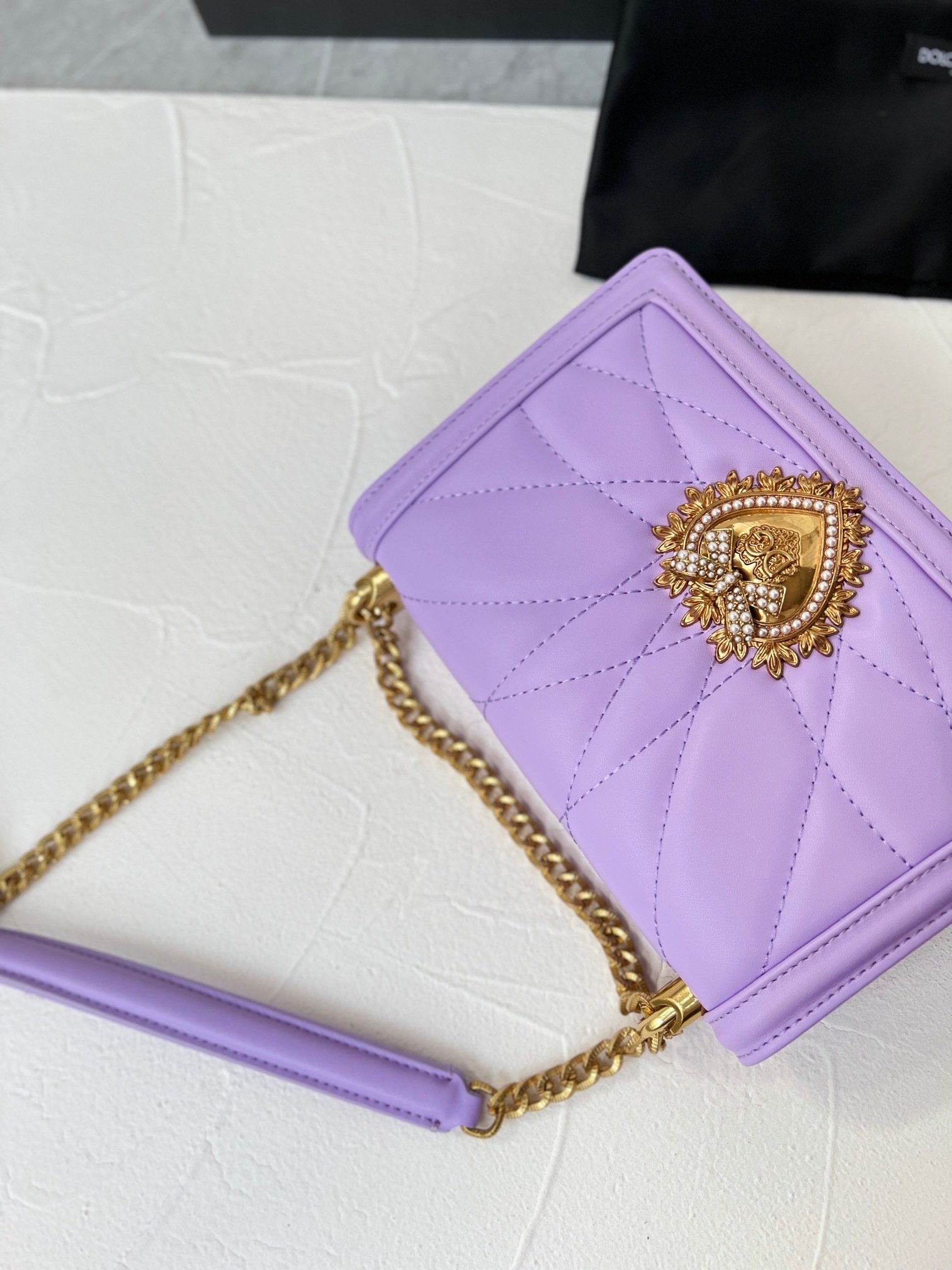 lavender quilted handbag with gold chain and heart emblem lavender quilted handbag with gold chain and heart emblem