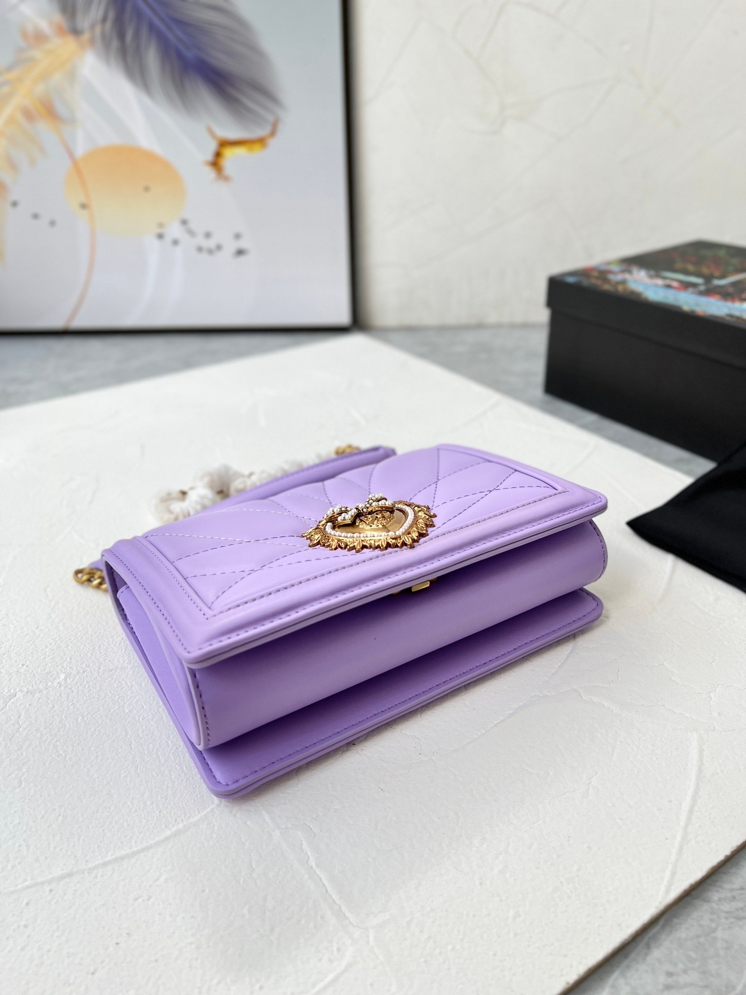 lavender quilted handbag with gold chain and heart emblem lavender quilted handbag with gold chain and heart emblem