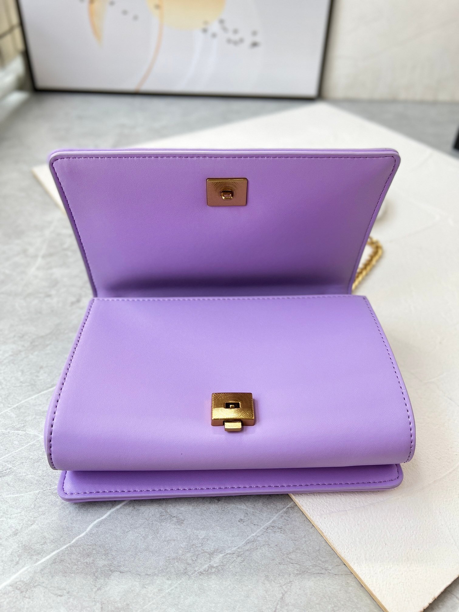 lavender quilted handbag with gold chain and heart emblem lavender quilted handbag with gold chain and heart emblem